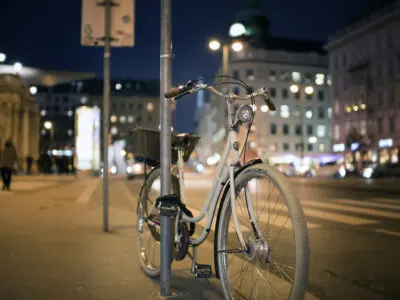 bicycle chained to a post at night