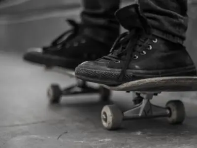 two black tennis shoes on a skateboard