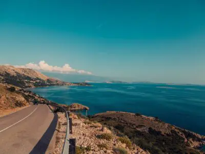 scenic roadway along a blue ocean coastline