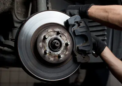 car mechanic working on brakes