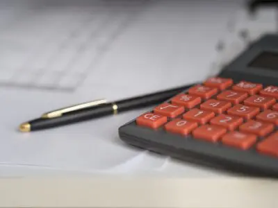 black pen with calculator and paperwork