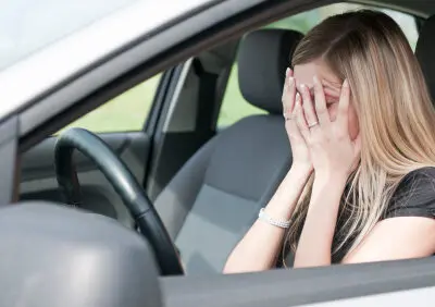 driver with head in her hands after an accident