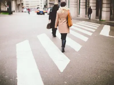 two people walking on a crosswalk