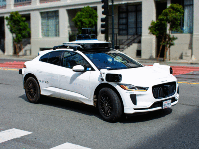 Waymo autonomous vehicle driving on a California city street, representing self-driving car technology, autonomous vehicle accidents, driverless transportation, potential liability involving manufacturers, software providers, fleet operators, and personal injury claims arising from autonomous vehicle collisions.