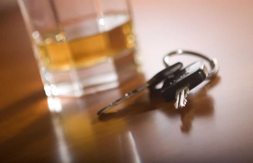 car keys sitting next to an alcoholic drink