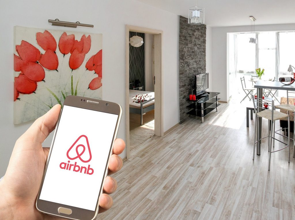 person using Airbnb app on their phone