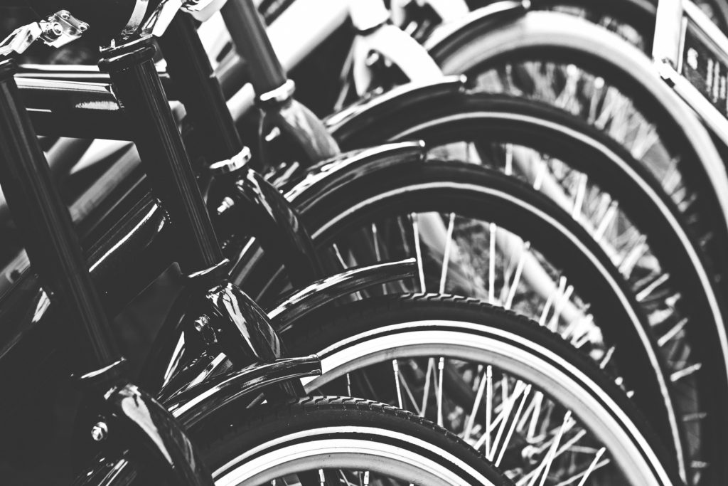 black & white photo of bikes lined up in a row