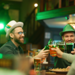 Men in green hats drinking in a bar. Saint Patricks day celebration.