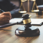 A judges gavel on a desk.